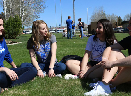 MCC students sitting on the grass